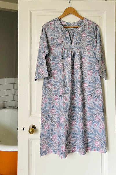 Front view of Caro Londons Kaftan nightie in grey and pink intertwining floral seed head print hanging on a bathroom door