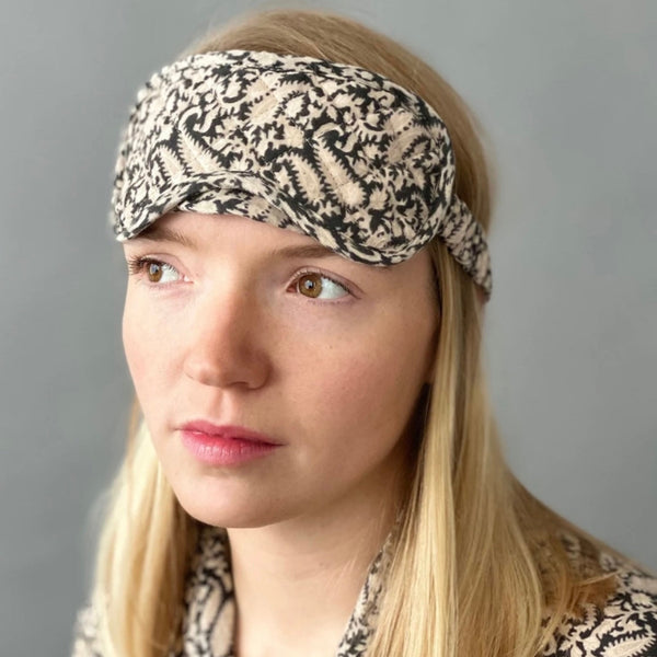 ladies quilted sleep mask in cream and black paisley print in soft cotton with adjustable strap by caro london