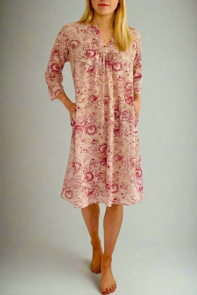 Woman wearing a pink pull on kaftan nightie in antique inspired pink floral