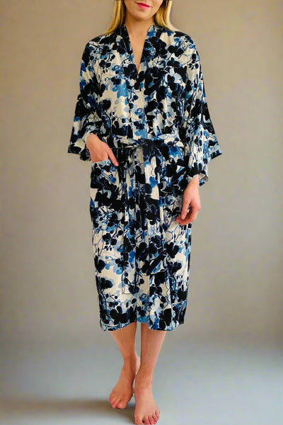 Ladies best selling wrap over kimono with tie belt with watercolour dark blue and blue floral on white ground. Made from heavy, silky viscose by Caro London.