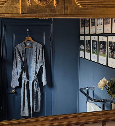 mens stripe kimono hanging on door and reflected in gold framed mirro