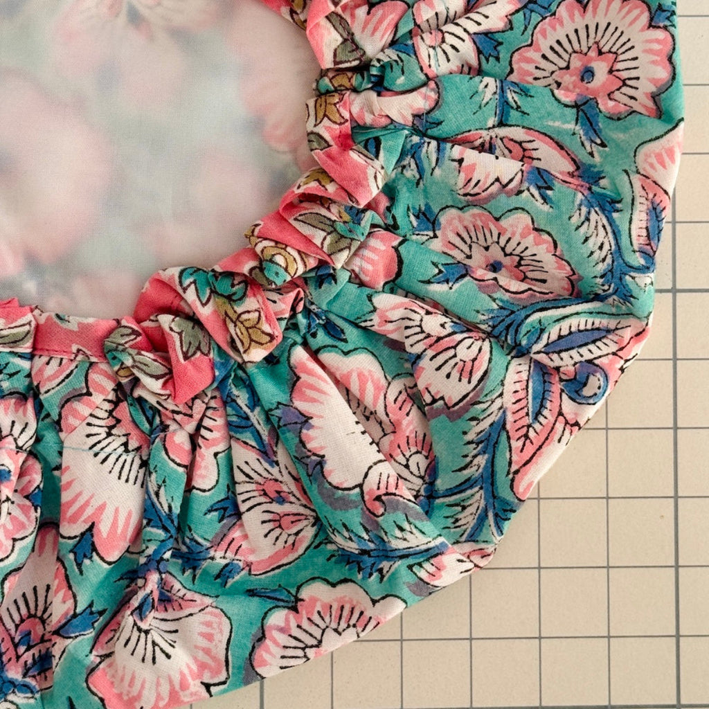 close up of floral print bath hat with white water resistant lining