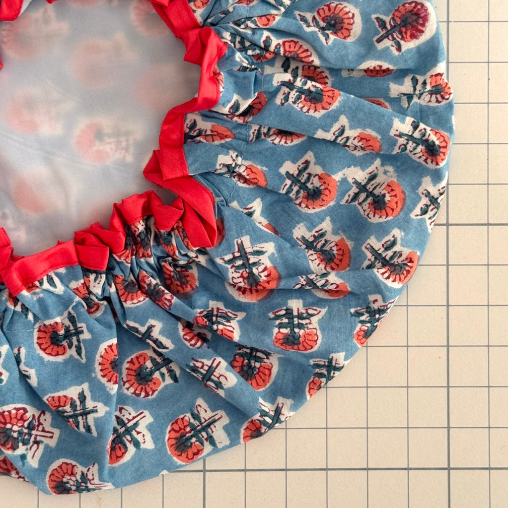 Close up of ditzy floral bath hat with contrast trim and white lining