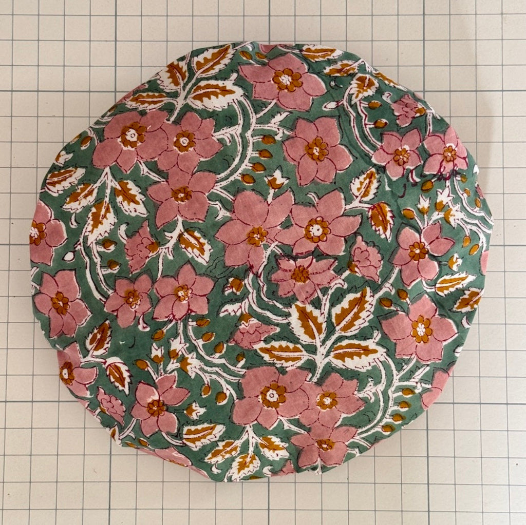 Pink, orange, white and green floral print bath hat made from cotton print