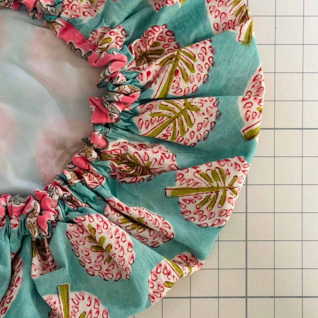 Close up of pine tree printed bath hat with contrast print binding and white lining