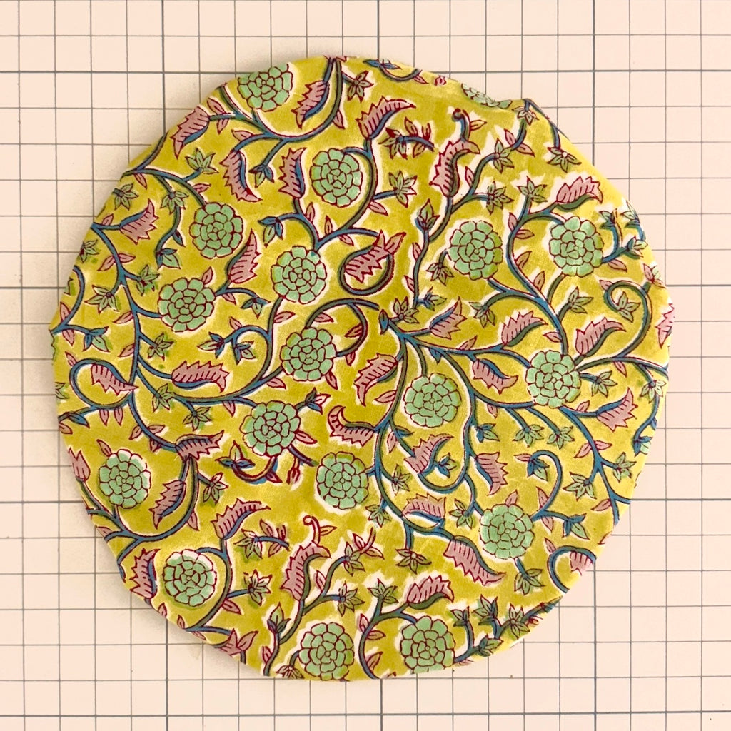 Cotton Bath Hat with a colorful yellow intertwining floral pattern on a grid background