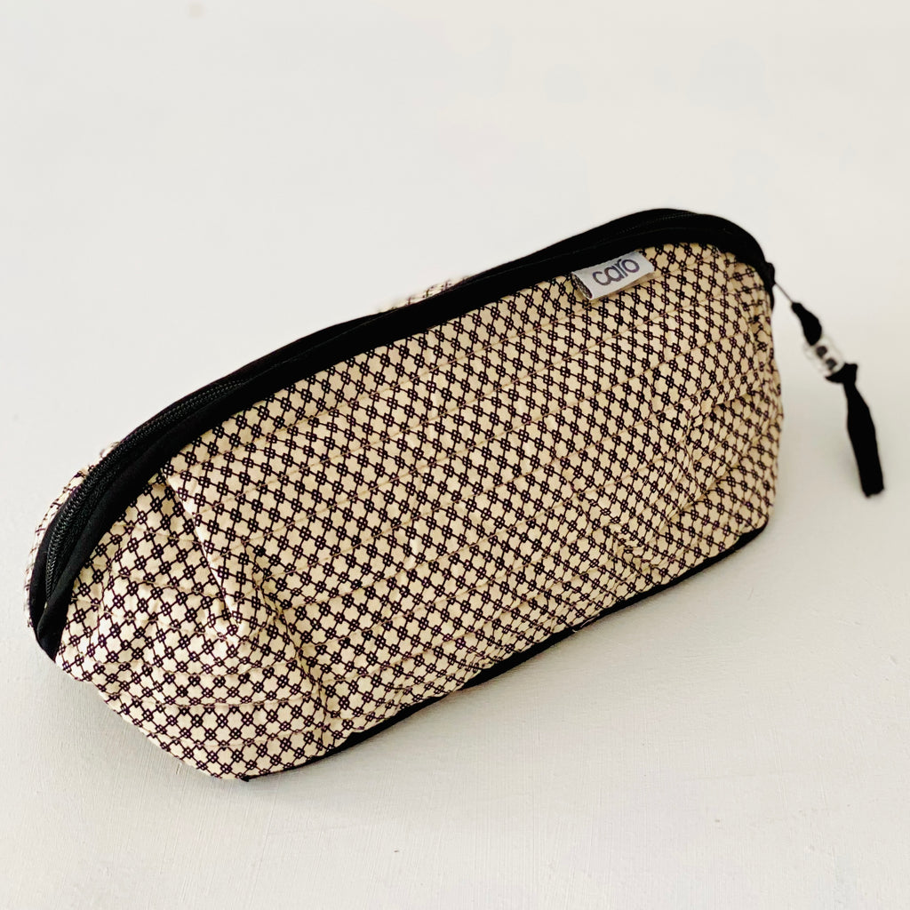 Bella long make up bag in black and cream black mini geometric print in quilted cotton with solid black trim and zip by Caro London