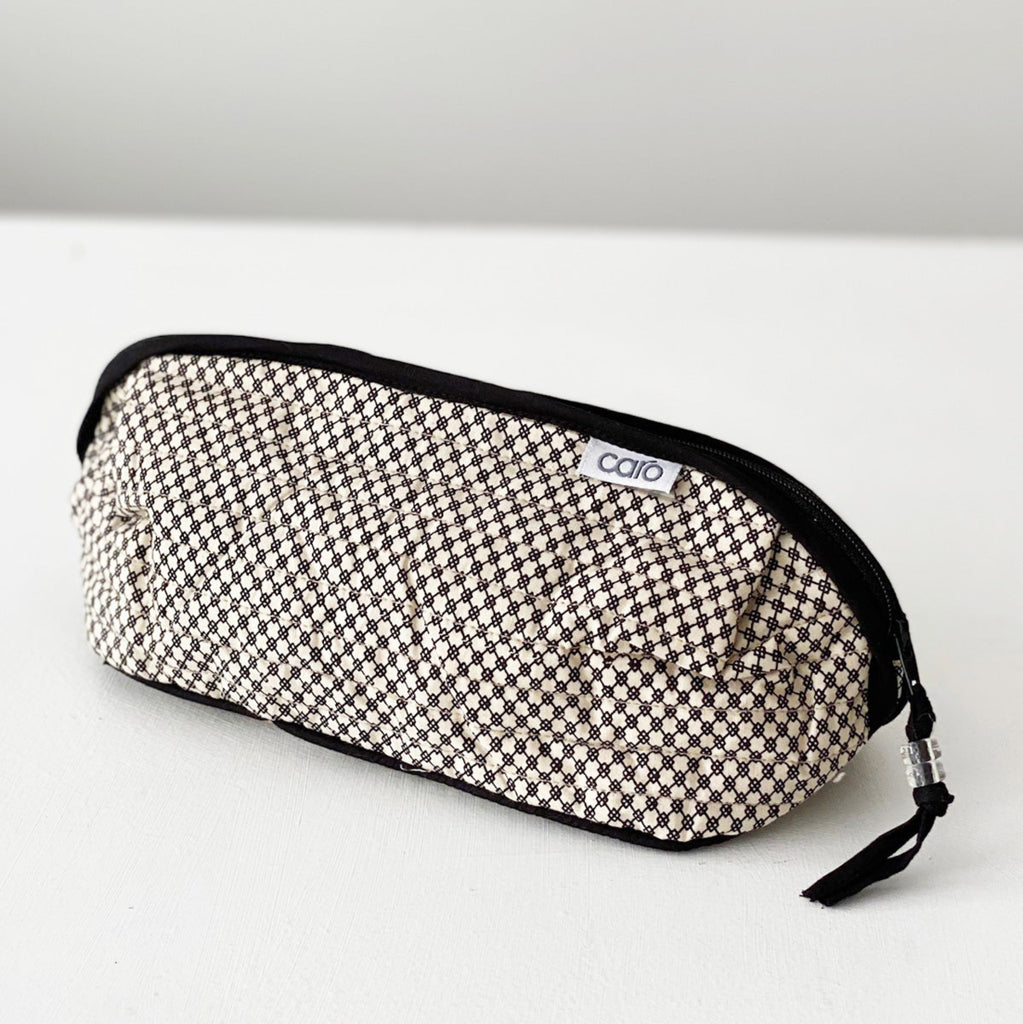 Bella long make up bag in black and cream black mini geometric print in quilted cotton with solid black trim and zip by Caro London