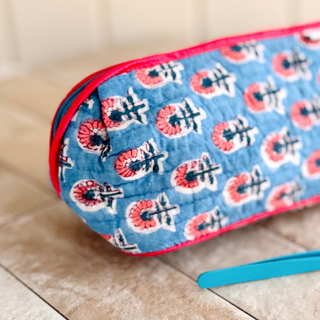 Close up of end of floral make up bag in blue and red floral