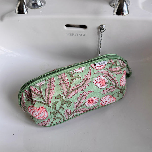 Floral patterned pouch on a white sink with 'Heritage' branding.