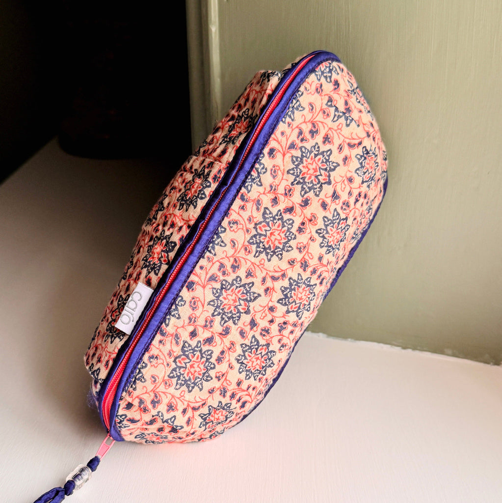 long, quilted make up bag in peach and blue floral print with dark blue trim