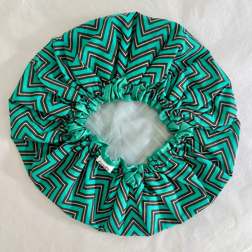 Caro bath hat made from turquoise zigzag cotton print with water resistant lining