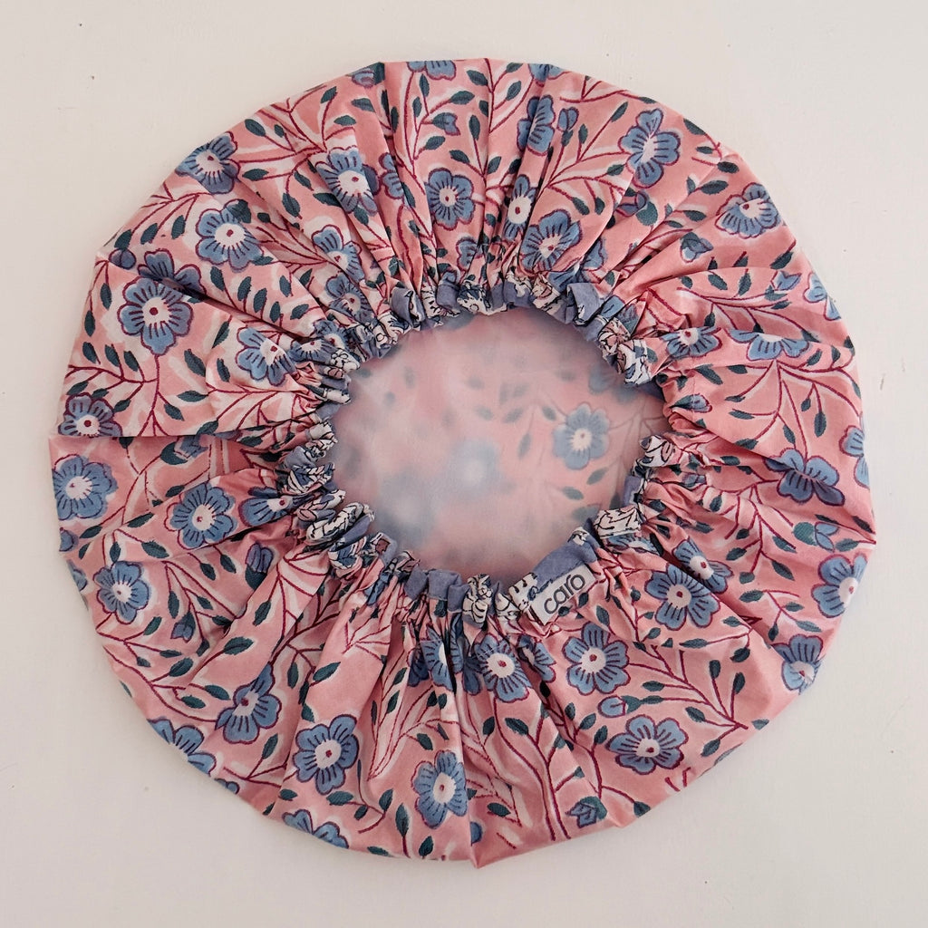 Shower Cap in pretty pink and blue floral pattern displayed on a light-colored surface