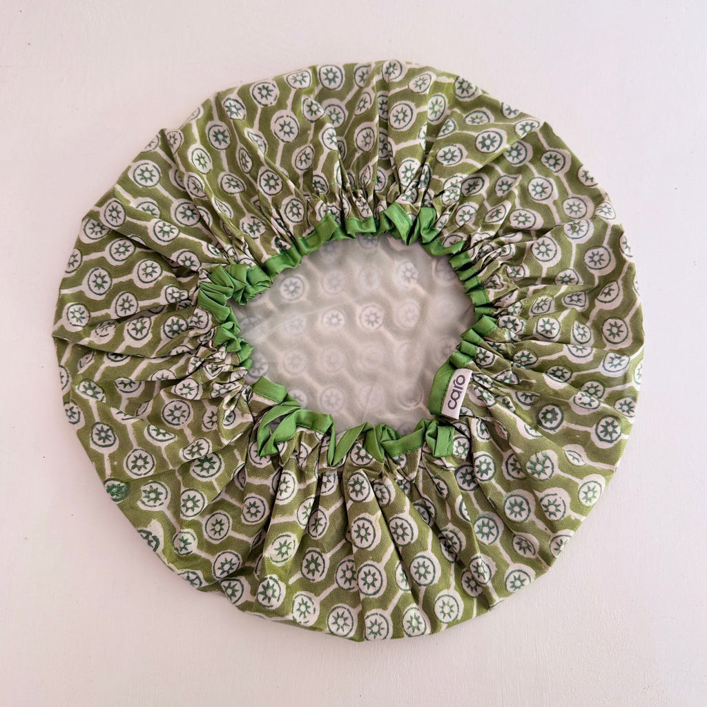 Interior of olive green and white geometric print waterproof shower cap.