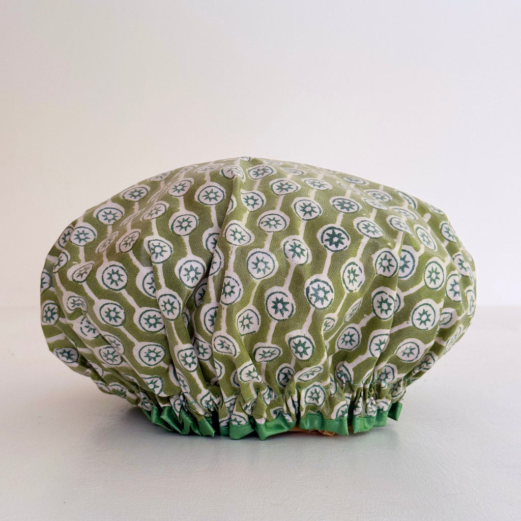 olive green and white geometric print waterproof shower cap.