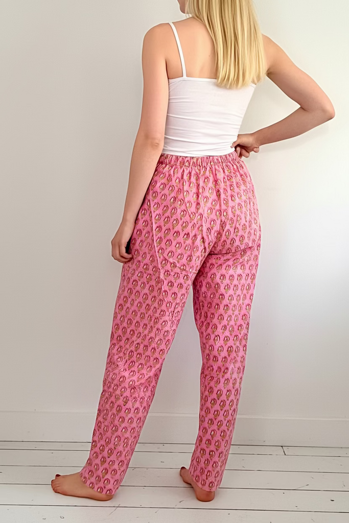 Back view of woman wearing Pink floral print easy Fit pyjama Bottoms and white camisole