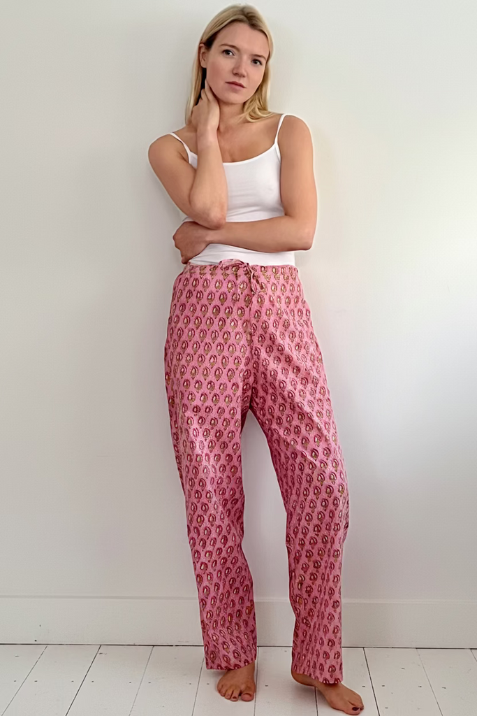 Woman wearing Pink floral print easy Fit pyjama Bottoms and white camisole