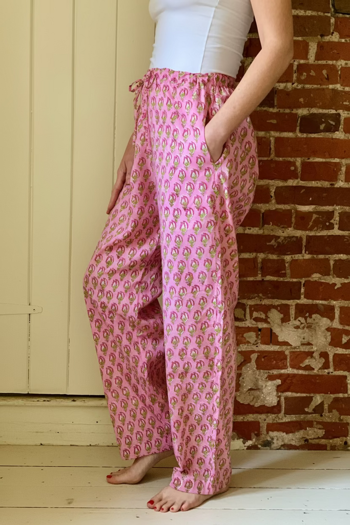 Side view of woman wearing Pink floral print easy Fit pyjama Bottoms and white camisole