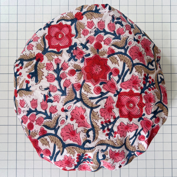 Cotton Bath hat made from pink, red and blue rambling all over floral block print. Keeps hair dry in the bath