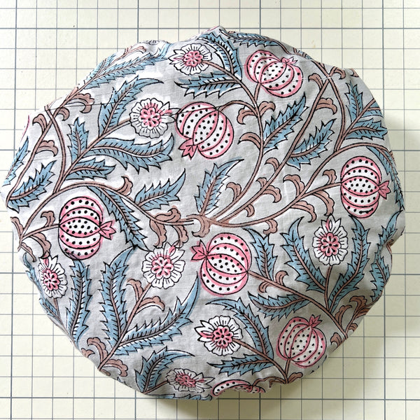 Cotton bath hat made from vintage feel seed head print with tudor style motifs in grey and pink. Has a white water resistant lining.