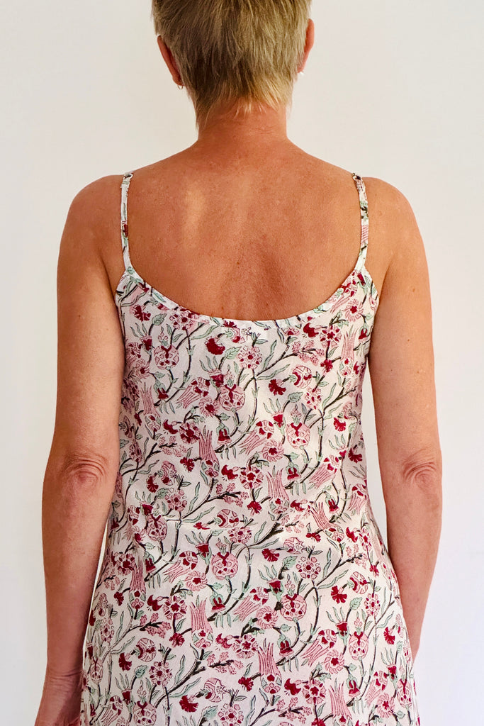 Person wearing a floral dress with a white background