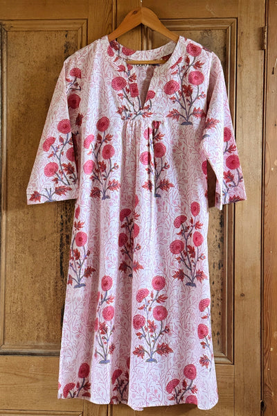 Floral nightdress on a hanger against a wooden door background