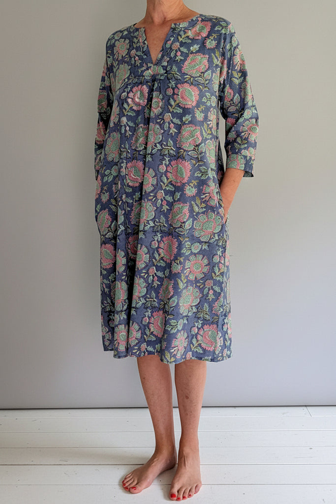 Person wearing a floral dress on a white background