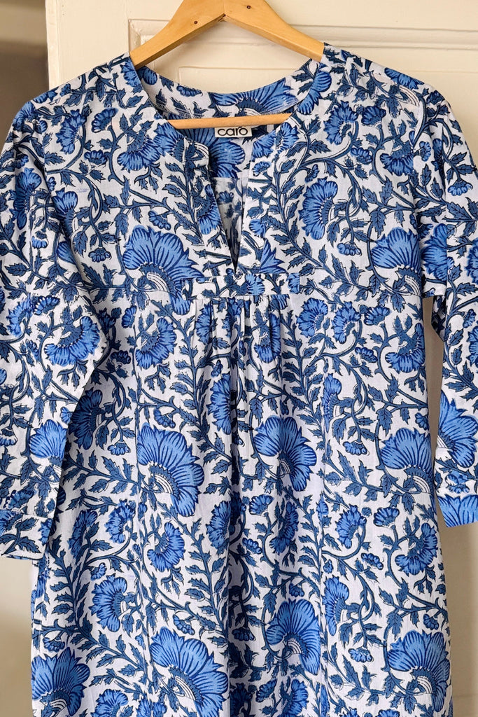 Blue floral nightdress on a hanger against a white background