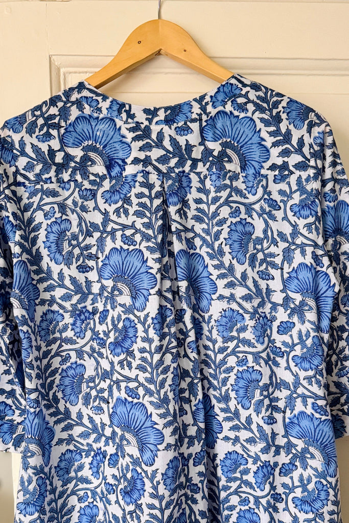 Blue floral nightdress on a hanger against a white wall