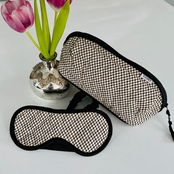 gift set with black mini geometric quilted eye mask and long bella make up bag in cream and black mini geometric print both items finished with black trim