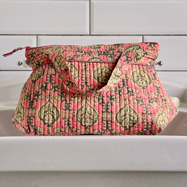Pink floral with tile print sitting on white sink