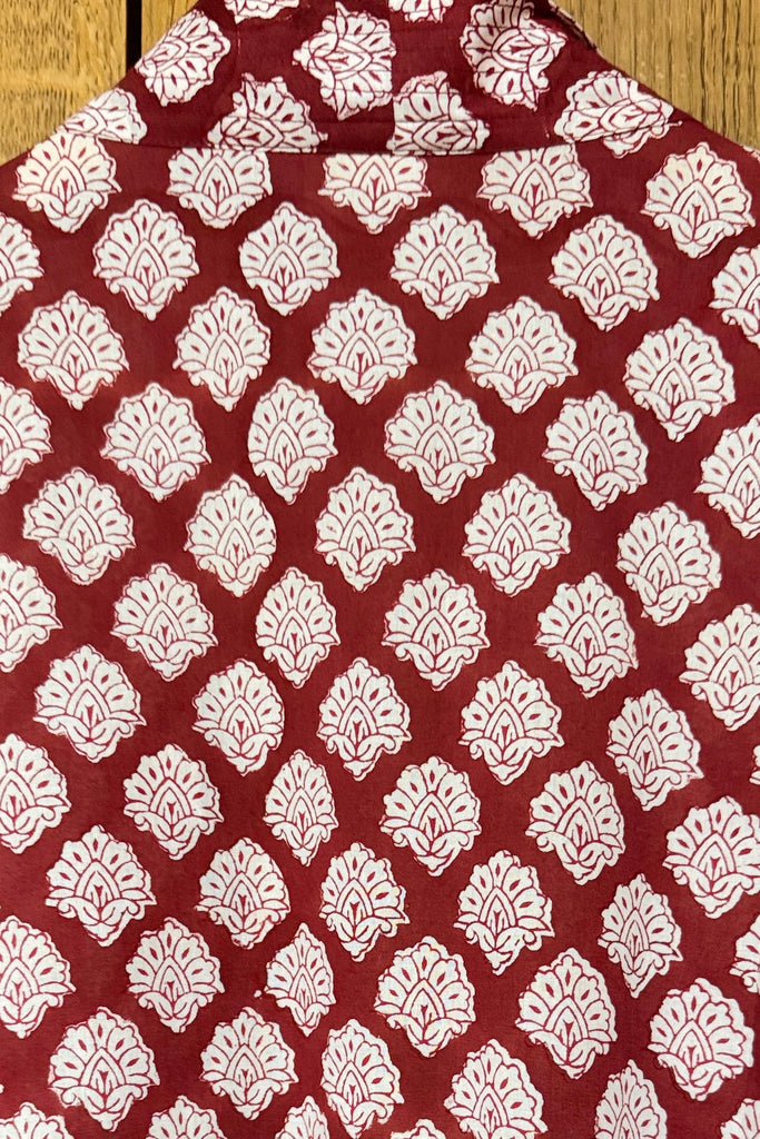 Red fabric with white geometric pattern on a wooden surface