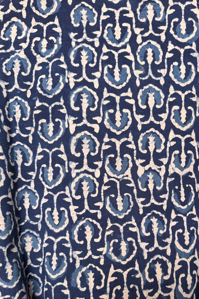 Patterned fabric with blue and white design on a blue background
