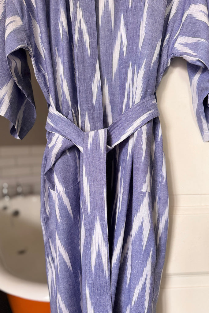 Blue and white patterned robe hanging against a door