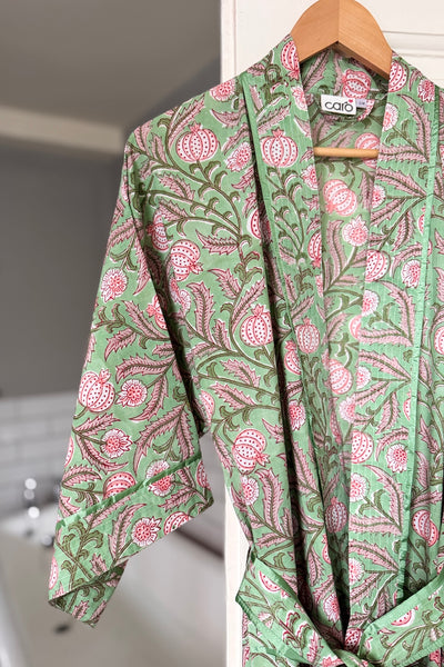 Green and pink patterned robe on a hanger