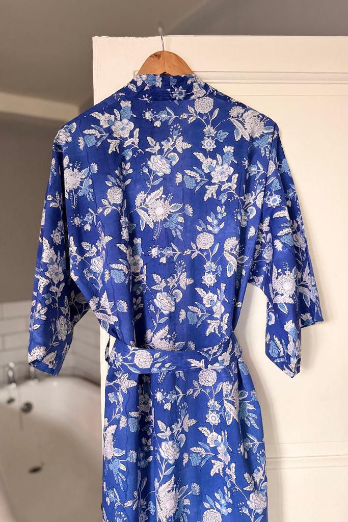 Blue floral robe hanging on a white door