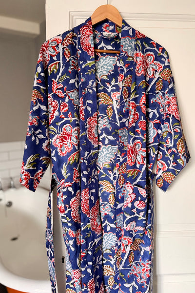 Floral-patterned robe hanging on a wooden hanger against a white background