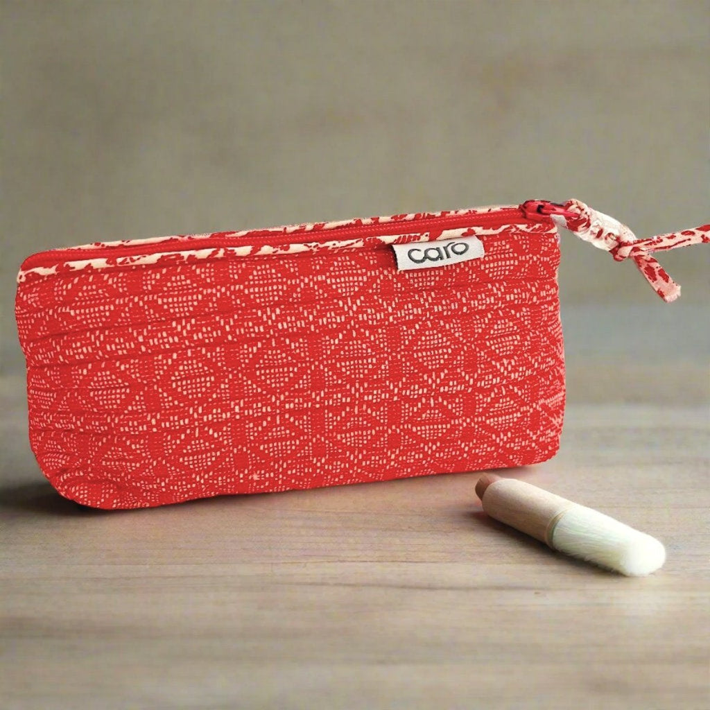 small red make up bag and cosmetics