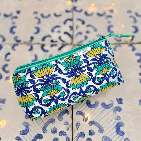 Floral patterned pouch with a green zipper on a tiled background