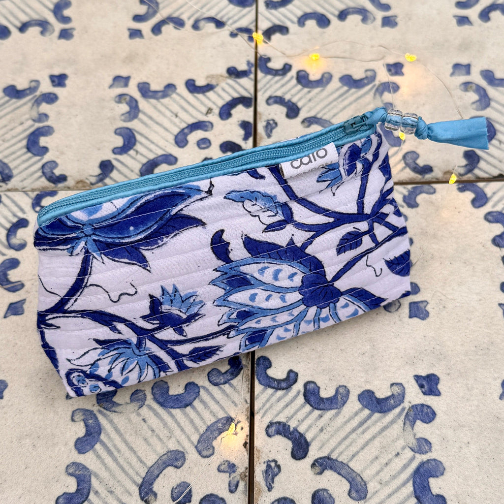 Blue and white floral patterned pouch on a tiled floor