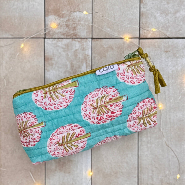 Fabric pouch with floral pattern on a tiled floor
