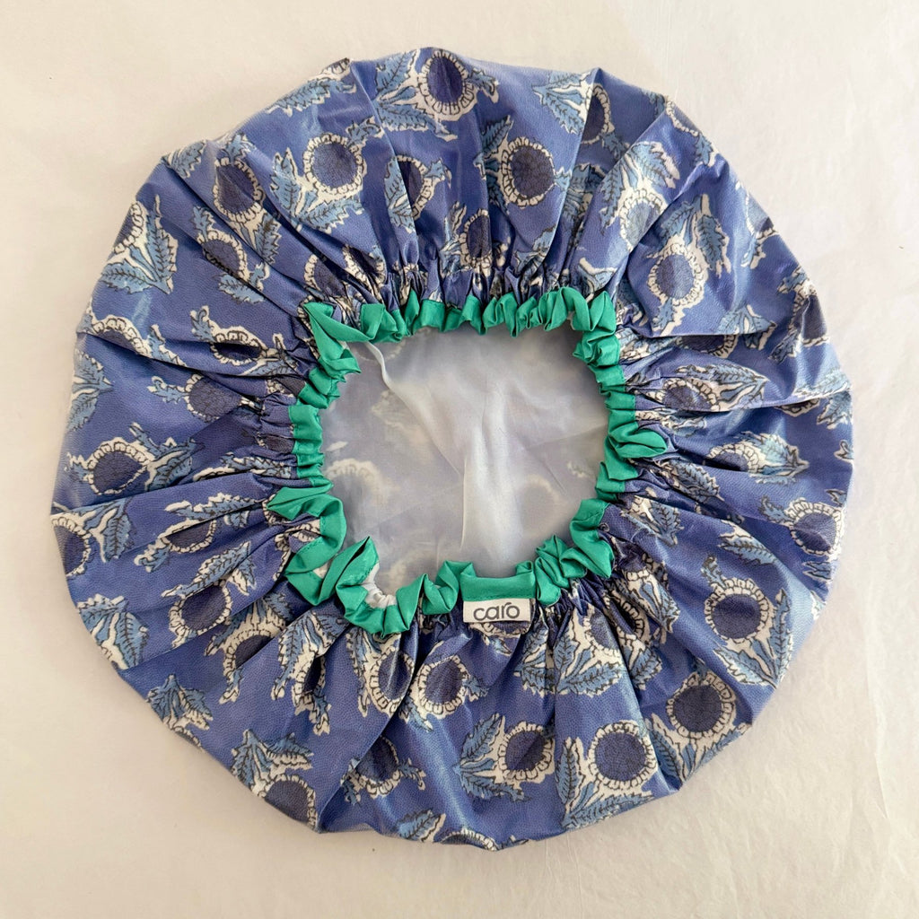 PHOTO OF INSIDE OF EN PROVENCE BLUE FLORAL SHOWER CAP SHOWING CONTRAST TURQUOISE TRIM