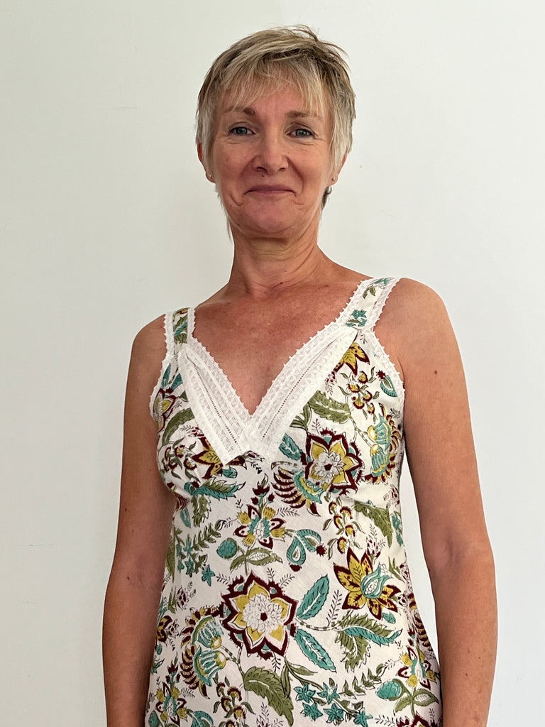 Very Lacey nightie is a bias cut slip, has soft gathering over the bust, adjustable straps, french seams, layered lace neck trim and is made from hand block print large scale floral in greens, turquoise, soft yellow and dark red on white ground