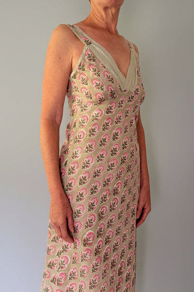 Woman wearing a floral dress with a plain background