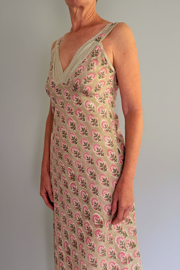 Woman wearing a floral dress with a plain background