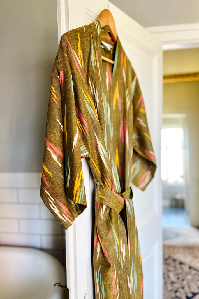 Colorful robe hanging on a door in a home setting