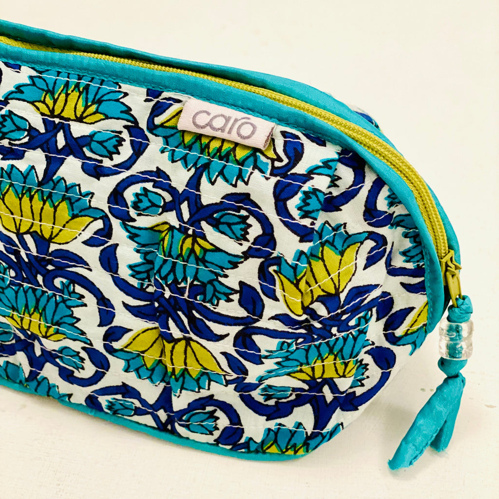 Patterned make up bag close up with blue and yellow design on a white background