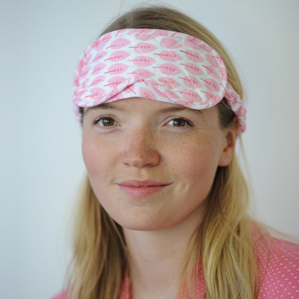 ladies sleep mask in quilted cotton with adjustable strap in soft cotton light pink leaf print on white ground  print by Caro London