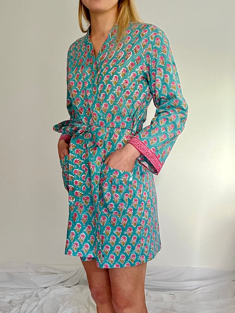 short kimono robe in hand printed small floral motif in pink on turquoise ground by caro london