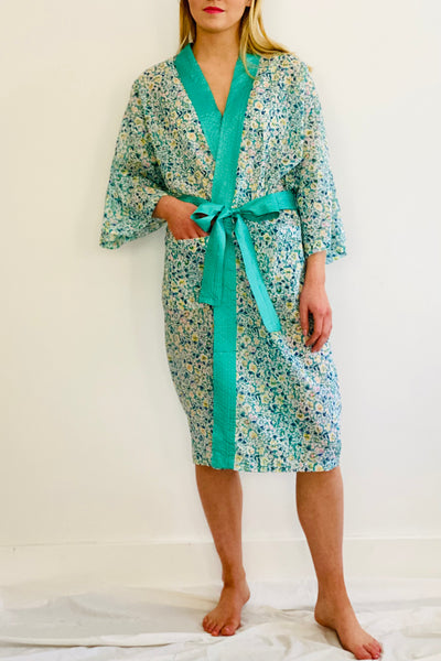 knee length kimono robe in lightweight cotton with small green and yellow floral print and turquoise trim neck band by caro london